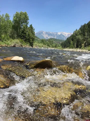 a view of a yard with a table and chairs