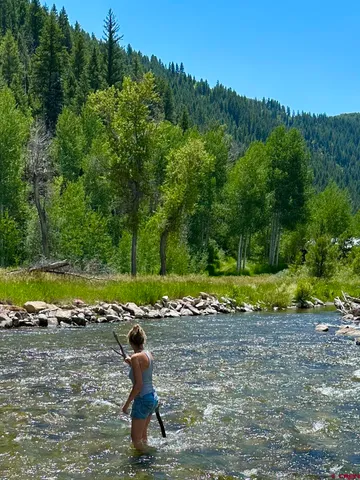 a swimming pool with outdoor seating and garden
