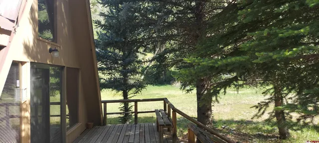 a view of balcony with wooden floor and fence