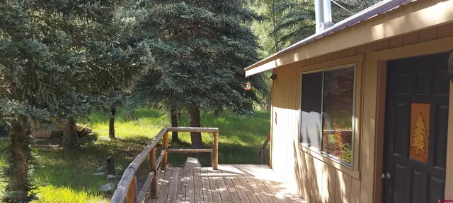 a view of a balcony with two chairs and a table