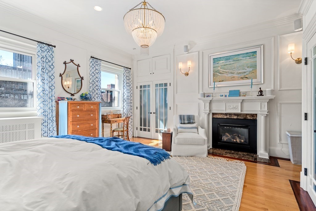 273 Commonwealth Avenue, Unit 9 Boston, MA 02116 - Photo 15 of 26 a bedroom with a bed dresser and a fireplace