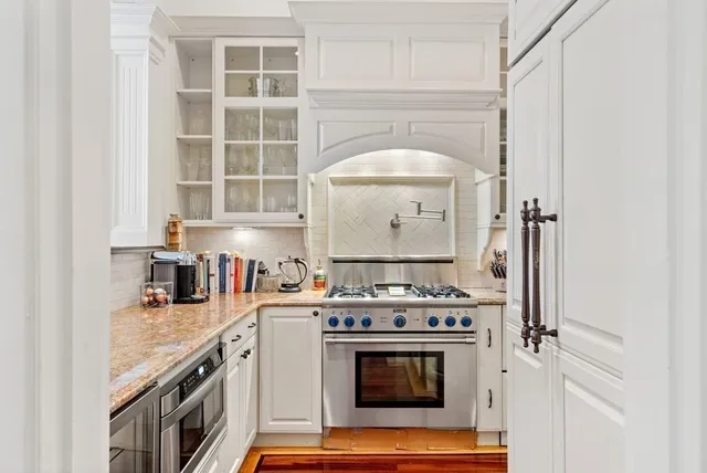 a kitchen with a stove top oven and cabinets