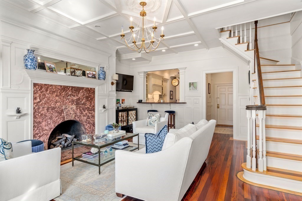 273 Commonwealth Avenue, Unit 9 Boston, MA 02116 - Photo 8 of 26 a living room with furniture a fireplace and a chandelier