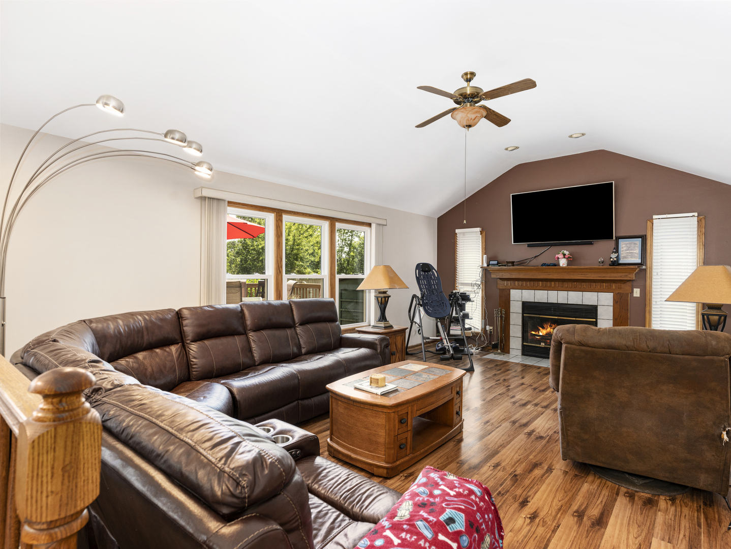2333 Hess Drive Crest Hill, IL 60403 - Photo 10 of 26 a living room with furniture a flat screen tv and a fireplace