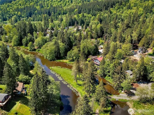 an aerial view of residential house with yard and swimming pool