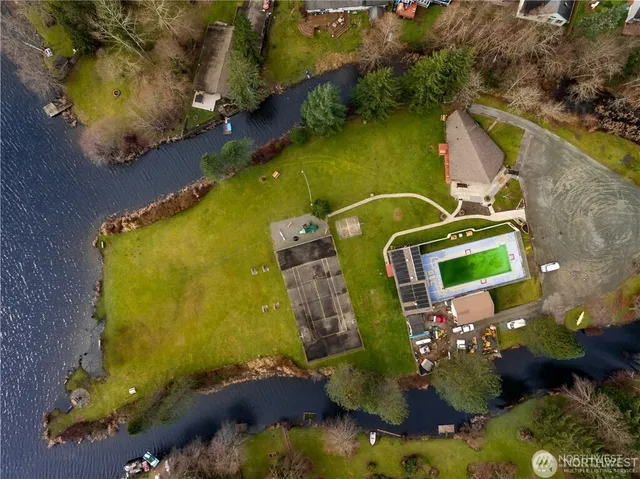 an aerial view of a house with a yard basket ball court and outdoor seating