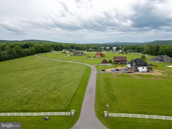 a view of a swimming pool with lawn chairs and couches
