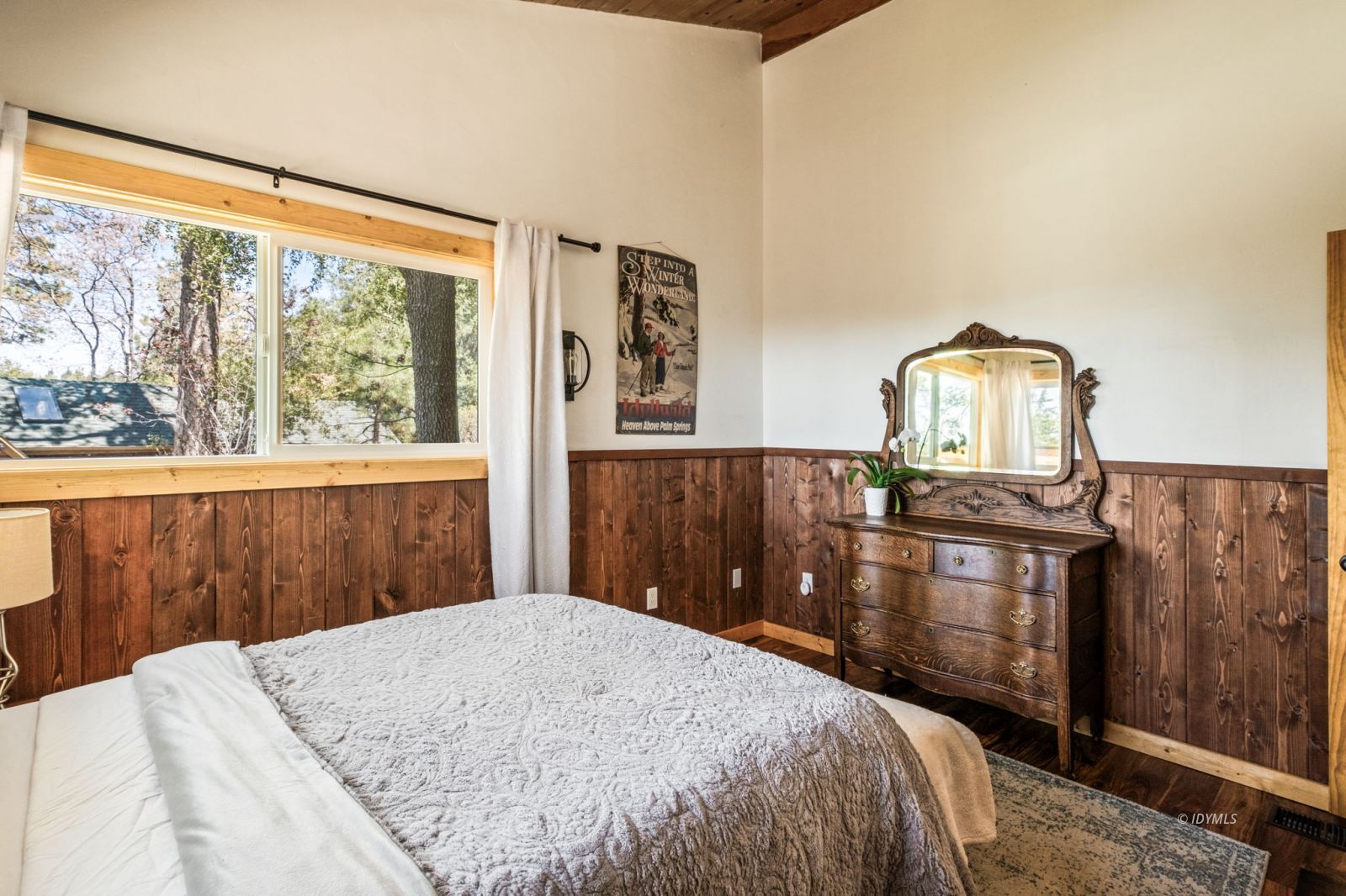 24750 Marion Ridge Drive Idyllwild, CA 92549 - Photo 33 of 45 a bedroom with a bed and dresser with mirror