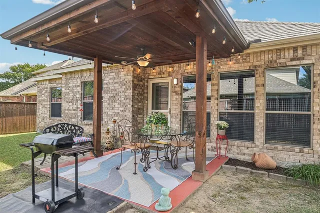 a building outdoor space with patio furniture and potted plants