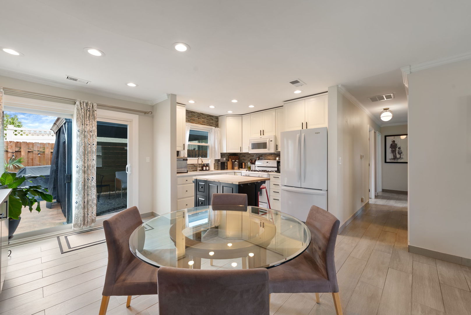5045 Rochester Drive Hoffman Estates, IL 60010 - Photo 13 of 33 a kitchen with a dining table chairs and refrigerator