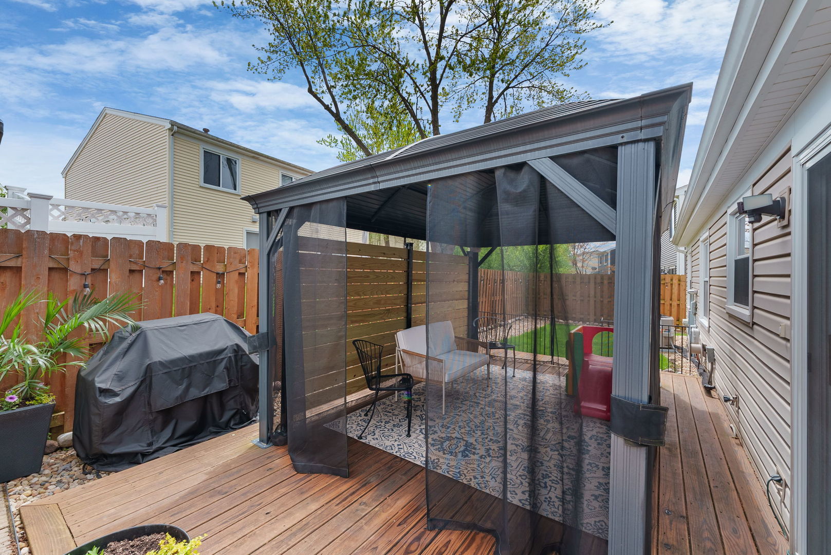 5045 Rochester Drive Hoffman Estates, IL 60010 - Photo 26 of 33 a view of deck with table and chairs under an umbrella with wooden floor