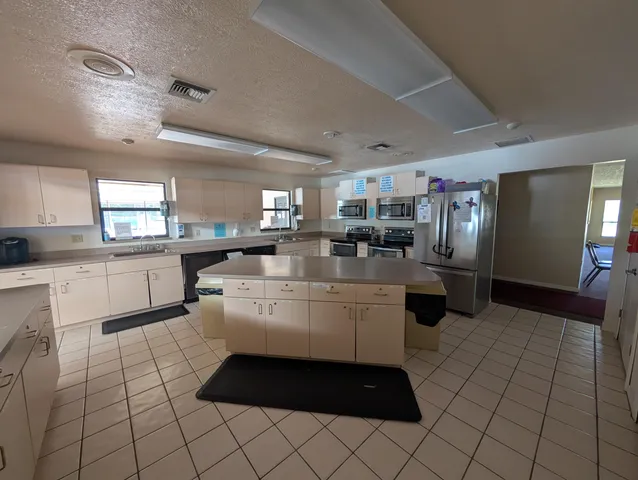 a kitchen with a stove and a wooden cabinets