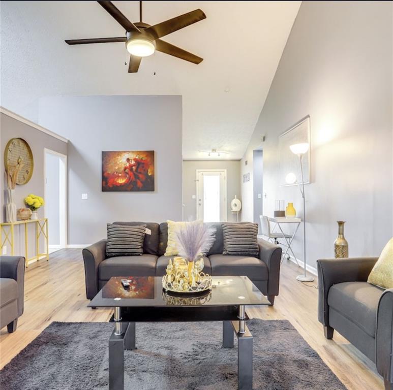 a living room with furniture and a wooden floor