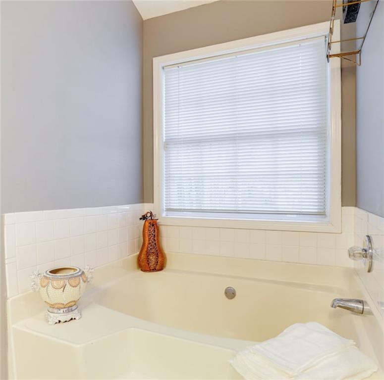 1080 Rafington Drive Lawrenceville, GA 30046 - Photo 13 of 19 a bathroom with a bathtub