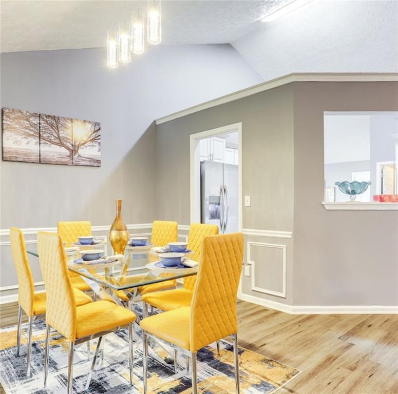 1080 Rafington Drive Lawrenceville, GA 30046 - Photo 15 of 19 a view of a dining room with furniture and wooden floor