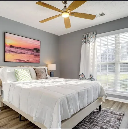 a bedroom with a large bed and a window