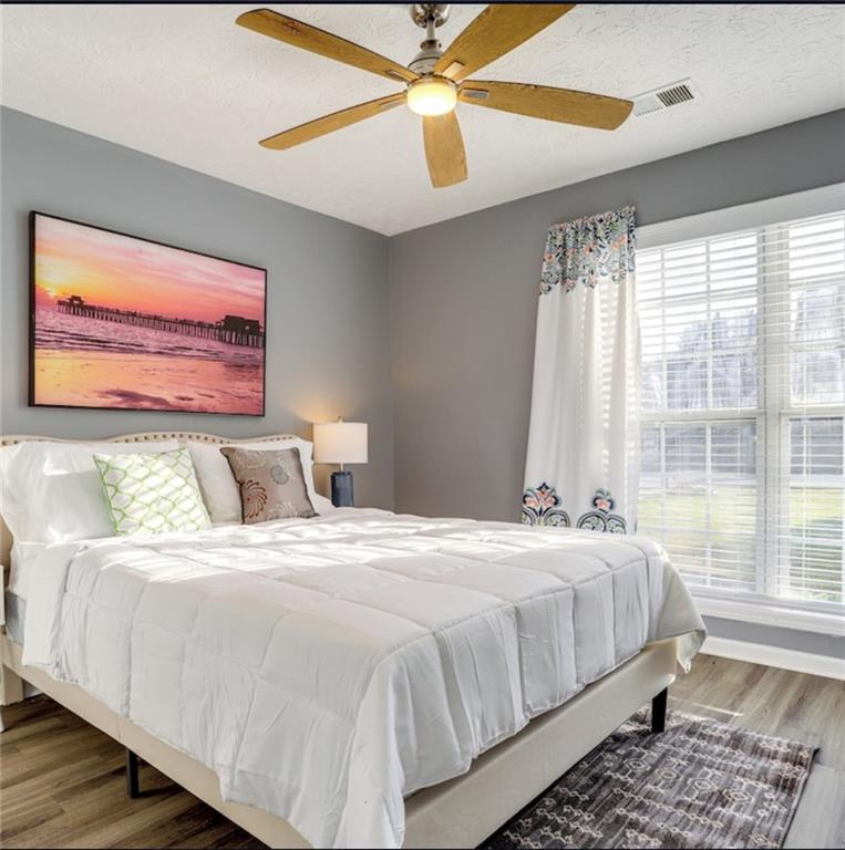 1080 Rafington Drive Lawrenceville, GA 30046 - Photo 10 of 19 a bedroom with a large bed and a window