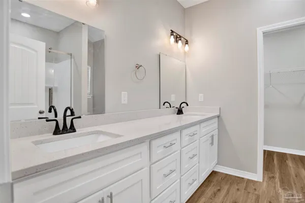 a bathroom with a double vanity sink and a mirror