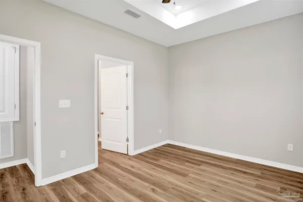 a view of a room with wooden floor