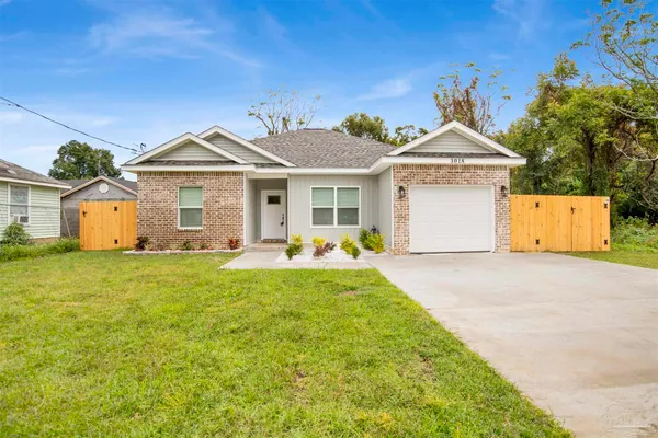 a front view of house with yard and trees
