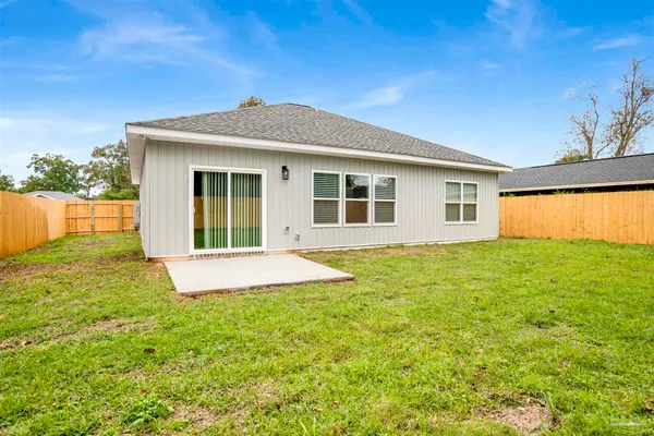 a view of an house with backyard space and garden