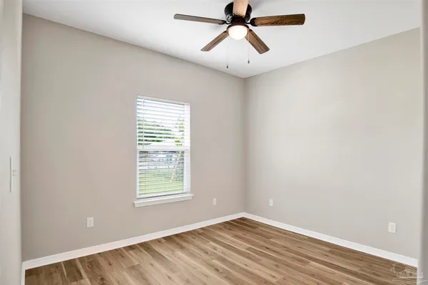 a view of a room with a window and a ceiling fan