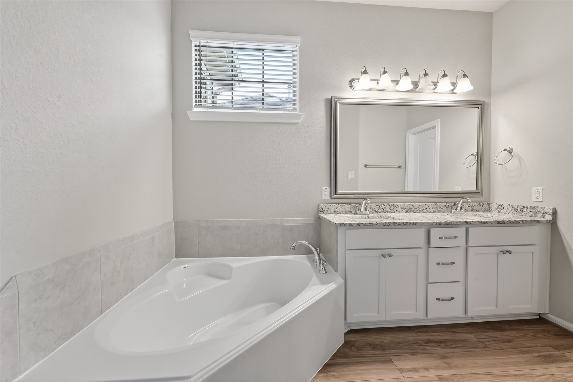 16226 Rattlesnake Run Trail Cypress, TX 77433 - Photo 20 of 29 a bathroom with a tub sink and mirror