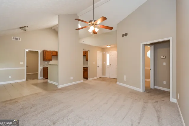a view of a livingroom with a chandelier fan