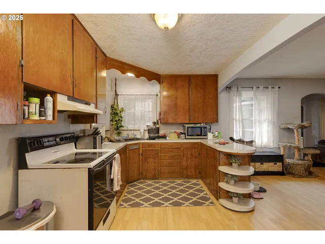 a kitchen that has a lot of cabinets a sink and a stove in it