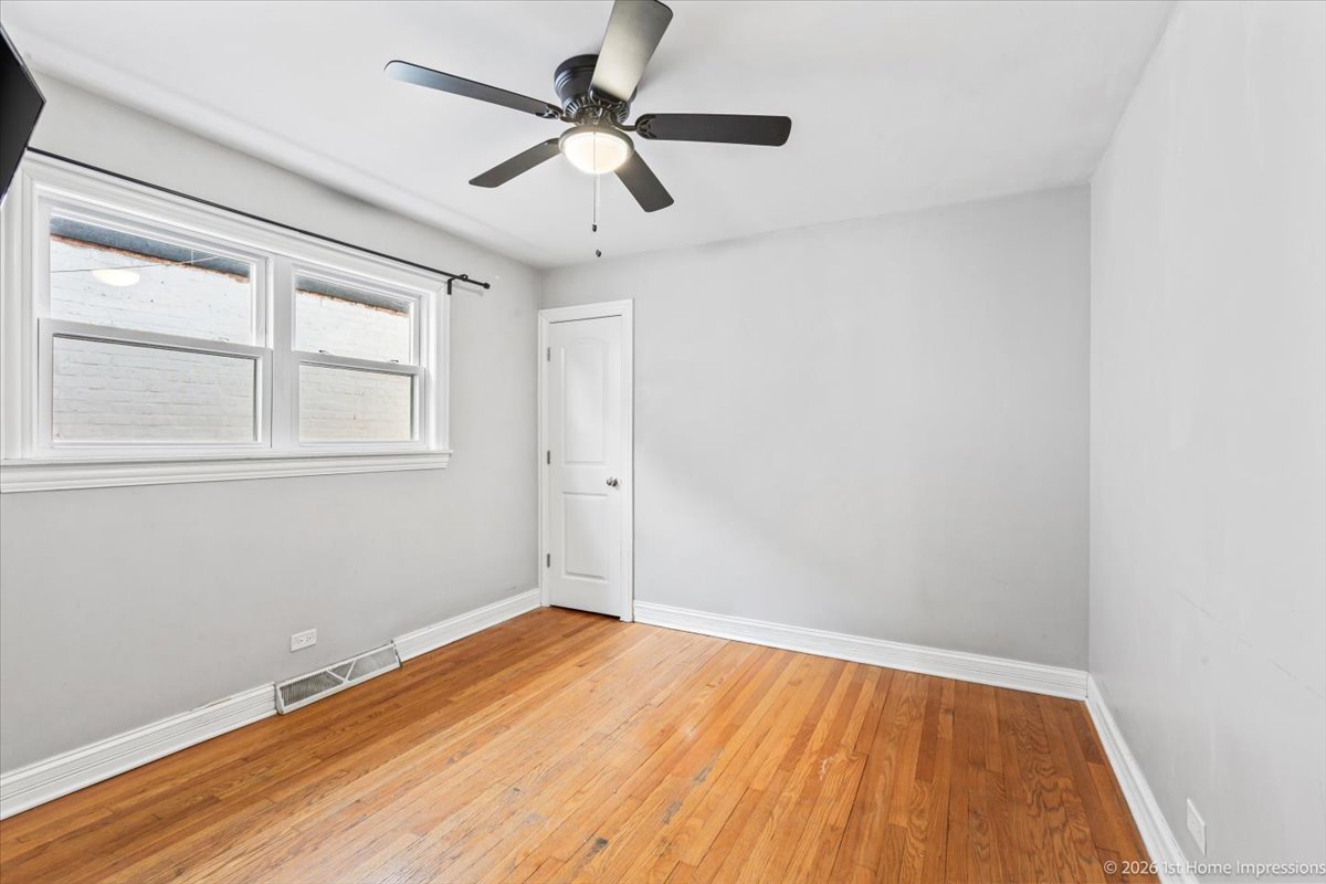 7205 South Hamlin Avenue Chicago, IL 60629 - Photo 11 of 24 an empty room with a window and a ceiling fan