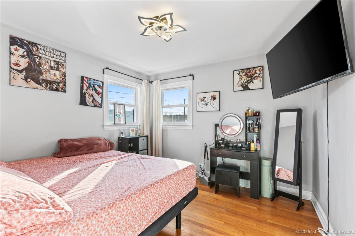 7205 South Hamlin Avenue Chicago, IL 60629 - Photo 12 of 24 a bedroom with a bed and a flat screen tv