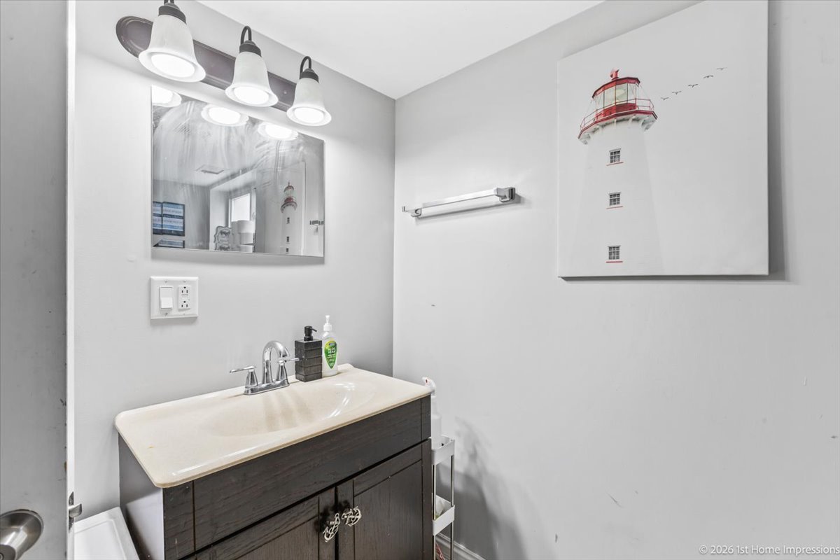 7205 South Hamlin Avenue Chicago, IL 60629 - Photo 18 of 24 a bathroom with a sink vanity and a mirror