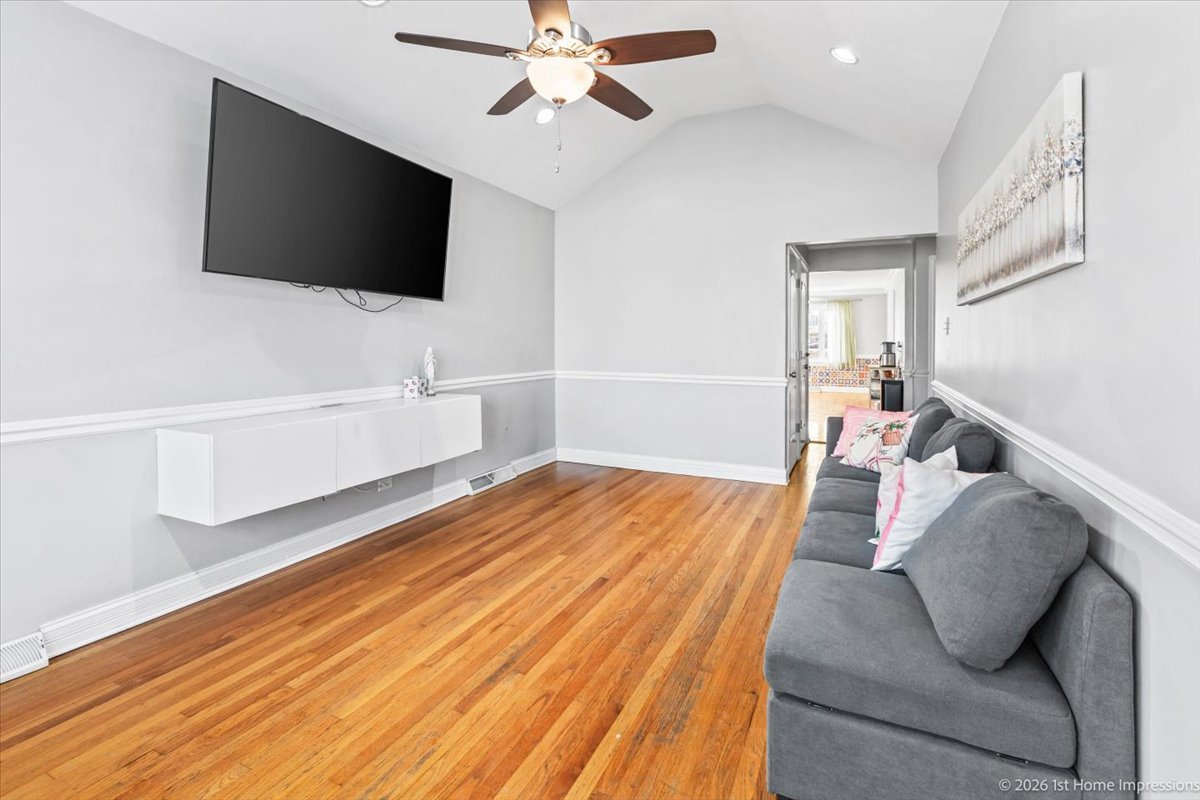 7205 South Hamlin Avenue Chicago, IL 60629 - Photo 2 of 24 a bedroom with a bed and a flat screen tv