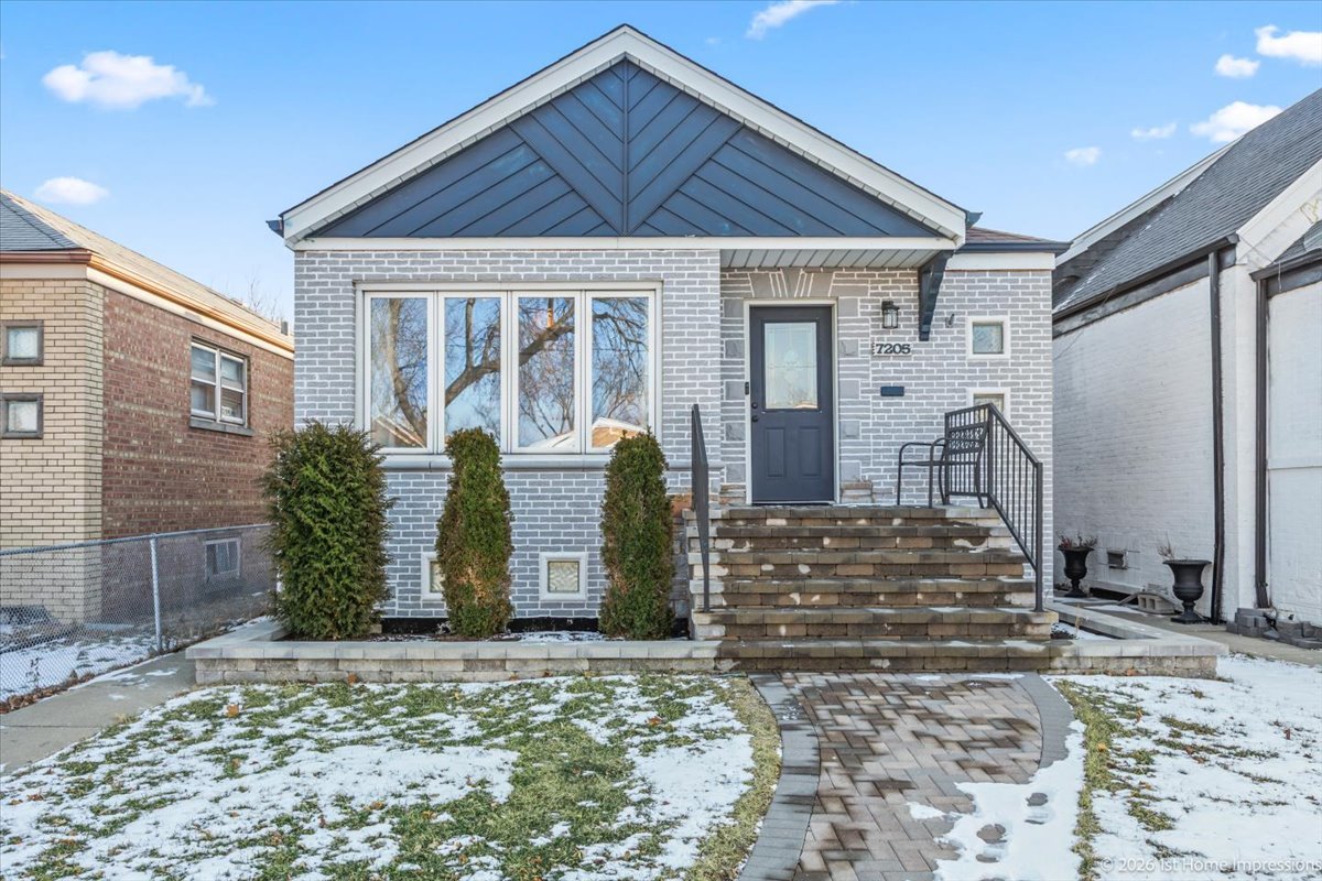 7205 South Hamlin Avenue Chicago, IL 60629 - Photo 24 of 24 a view of a house with large windows and plants