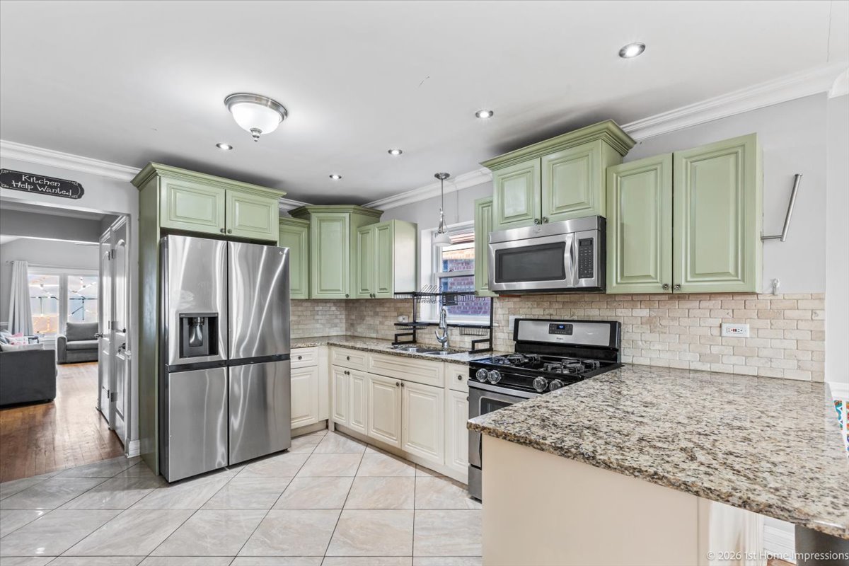7205 South Hamlin Avenue Chicago, IL 60629 - Photo 5 of 24 a kitchen with stainless steel appliances granite countertop a refrigerator and a sink