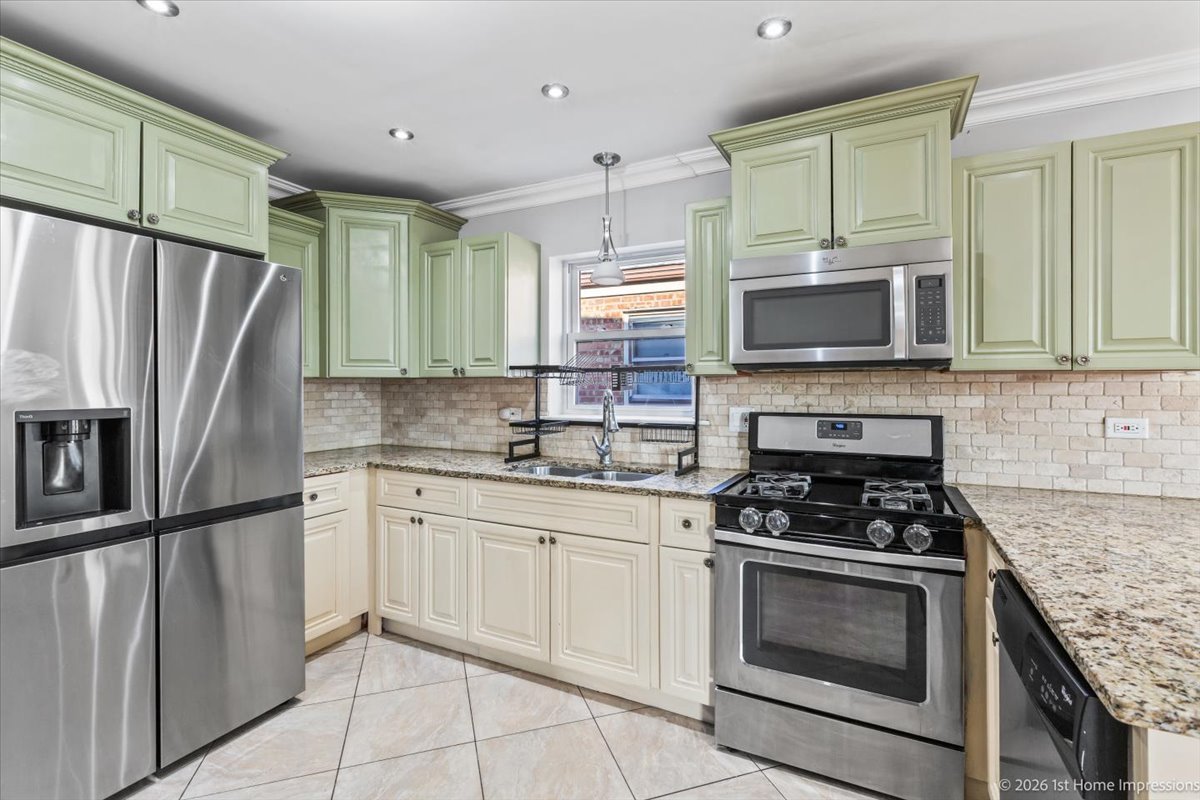 7205 South Hamlin Avenue Chicago, IL 60629 - Photo 6 of 24 a kitchen with granite countertop a refrigerator stove and microwave