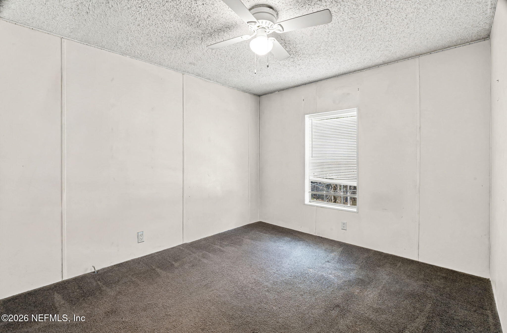 2910 Marshbank Road Jacksonville, FL 32224 - Photo 29 of 45 an empty room with a ceiling fan and a window