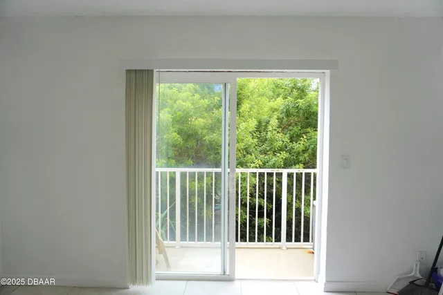 an empty room with closet and a hallway