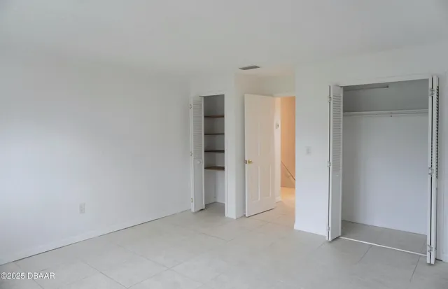 a view of a hallway with wooden floor and entryway