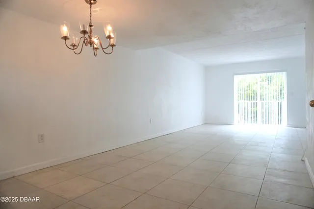 a view of an empty room with a chandelier