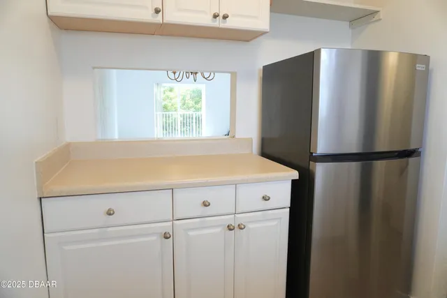 a kitchen with a refrigerator and a window