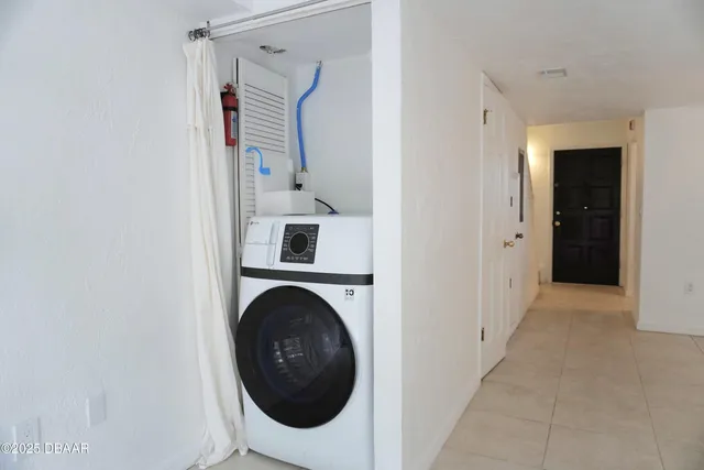 a view of a hallway with washer and dryer