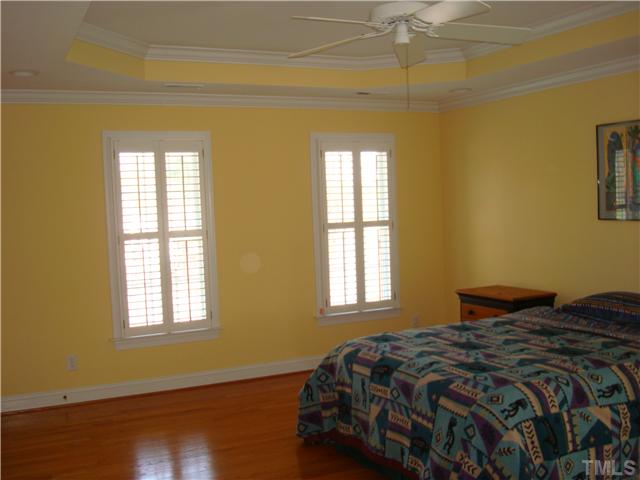 4105 Heathgate Lane Raleigh, NC 27613 - Photo 11 of 12 Master Bedroom has beautiful try ceiling, plantation shutters, and two large walk in closets.
