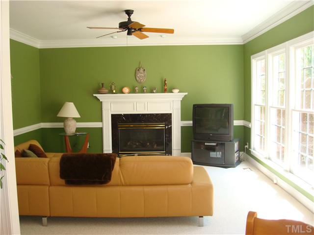 4105 Heathgate Lane Raleigh, NC 27613 - Photo 4 of 12 Family room viewed from the kichen has gas log fireplace with attractive mantel, and a bank of windows.