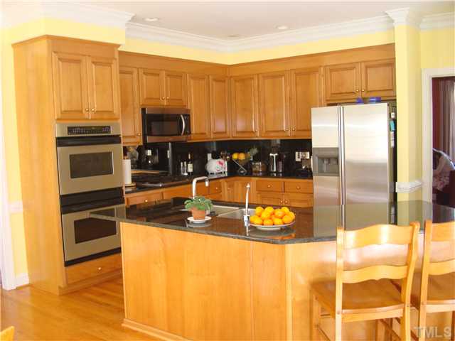 4105 Heathgate Lane Raleigh, NC 27613 - Photo 6 of 12 Kitchen has everything the gourmet cook dreams of including two pantries, two ovens, new bui;t in microwave, and a gas cooktop.