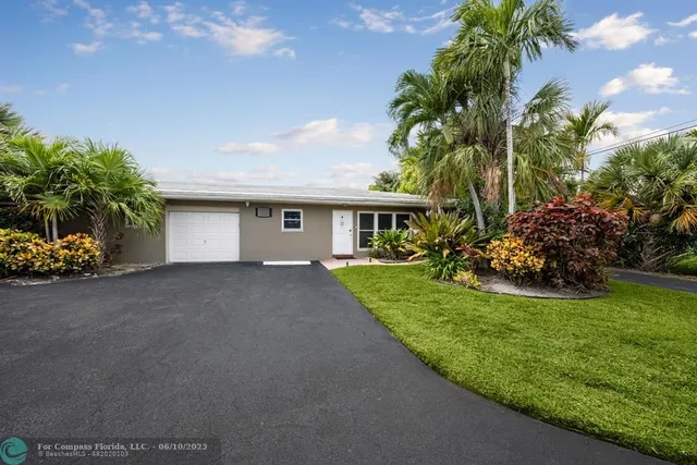 a front view of house with a garden
