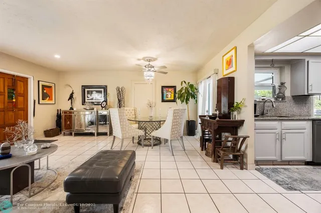a living room with furniture a dining table and chairs with wooden floor