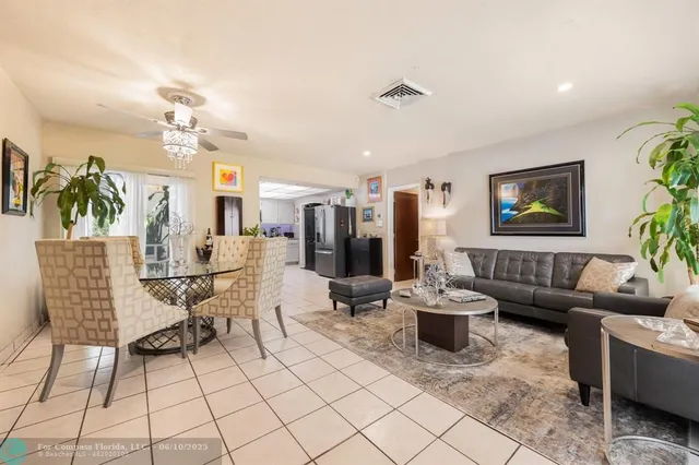 a living room with fireplace furniture and a potted plant