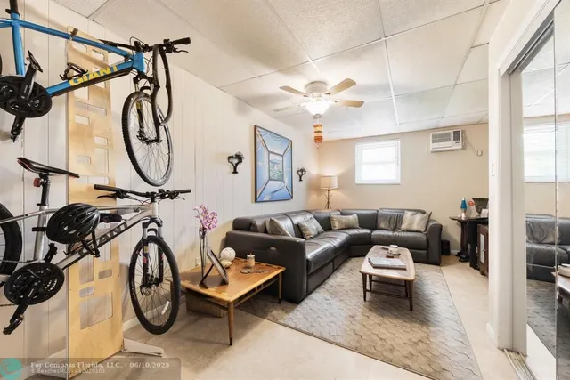 a living room with furniture a air conditioner and a window