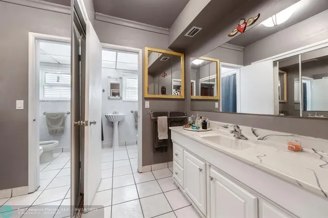 a spacious bathroom with a sink a mirror and a shower